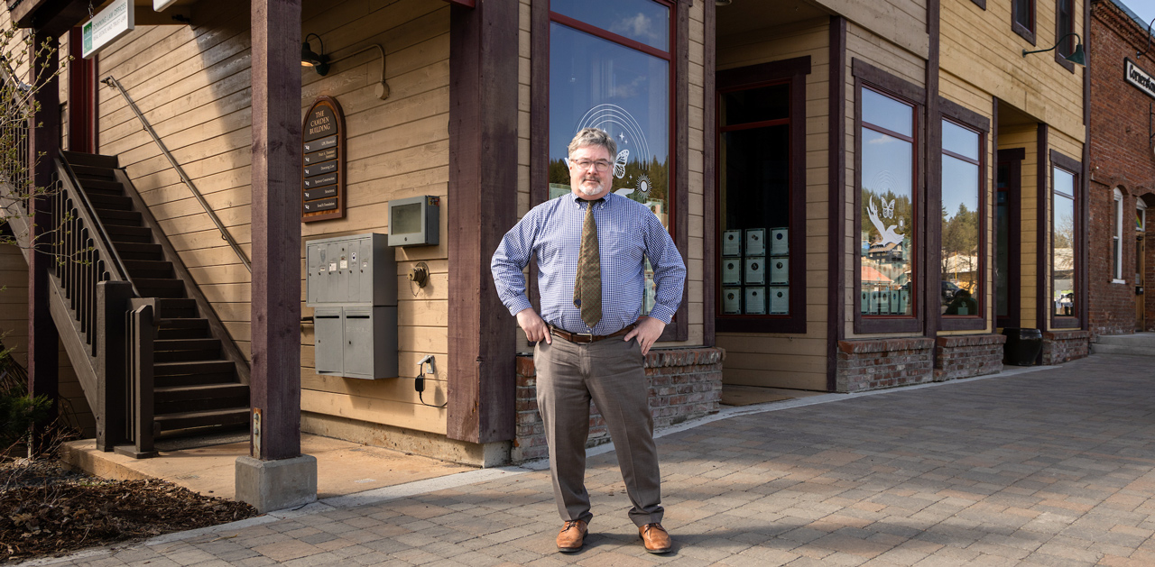 John Downing standing in front of office building